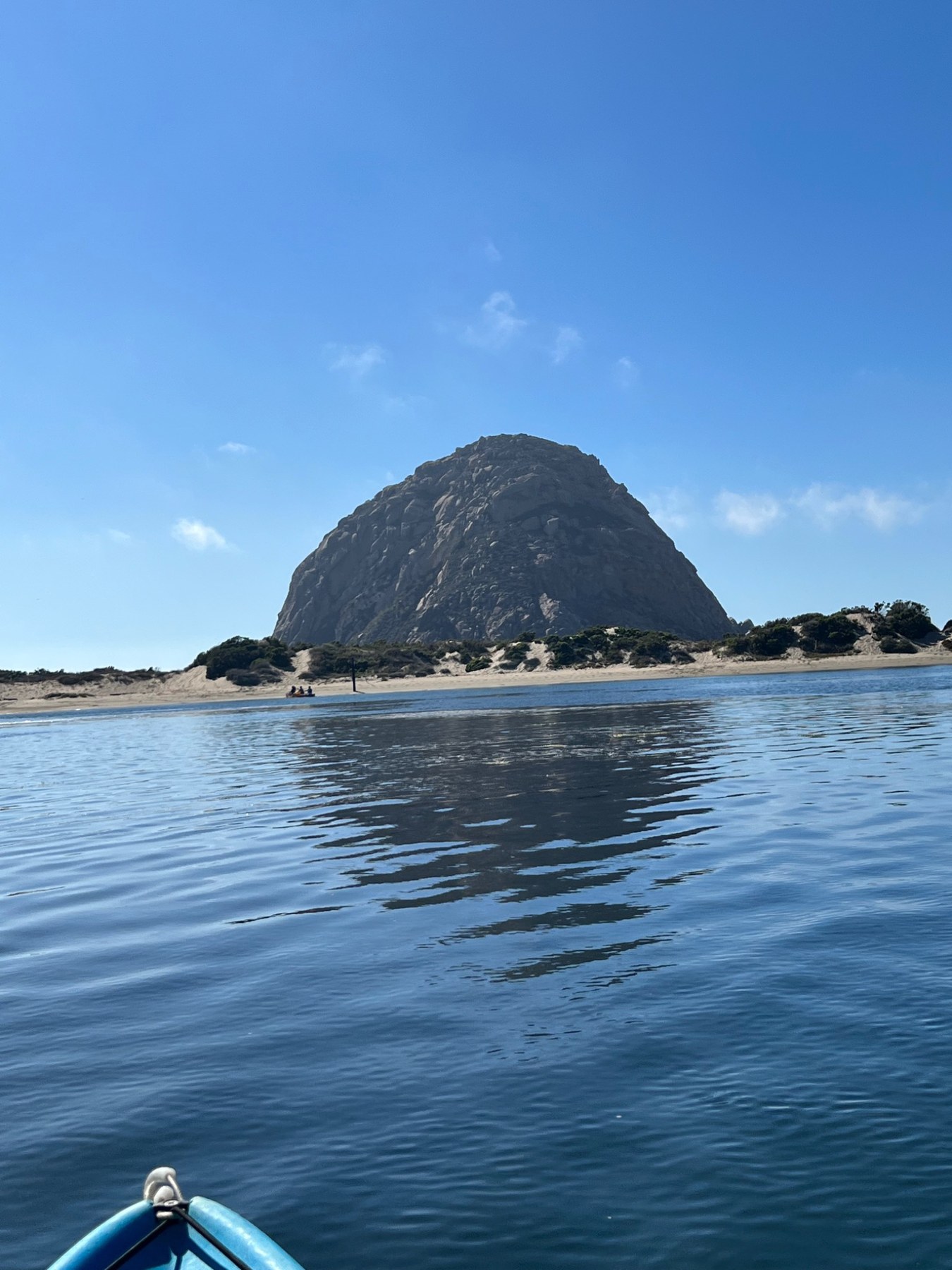 View of Morro Rock over calm water
